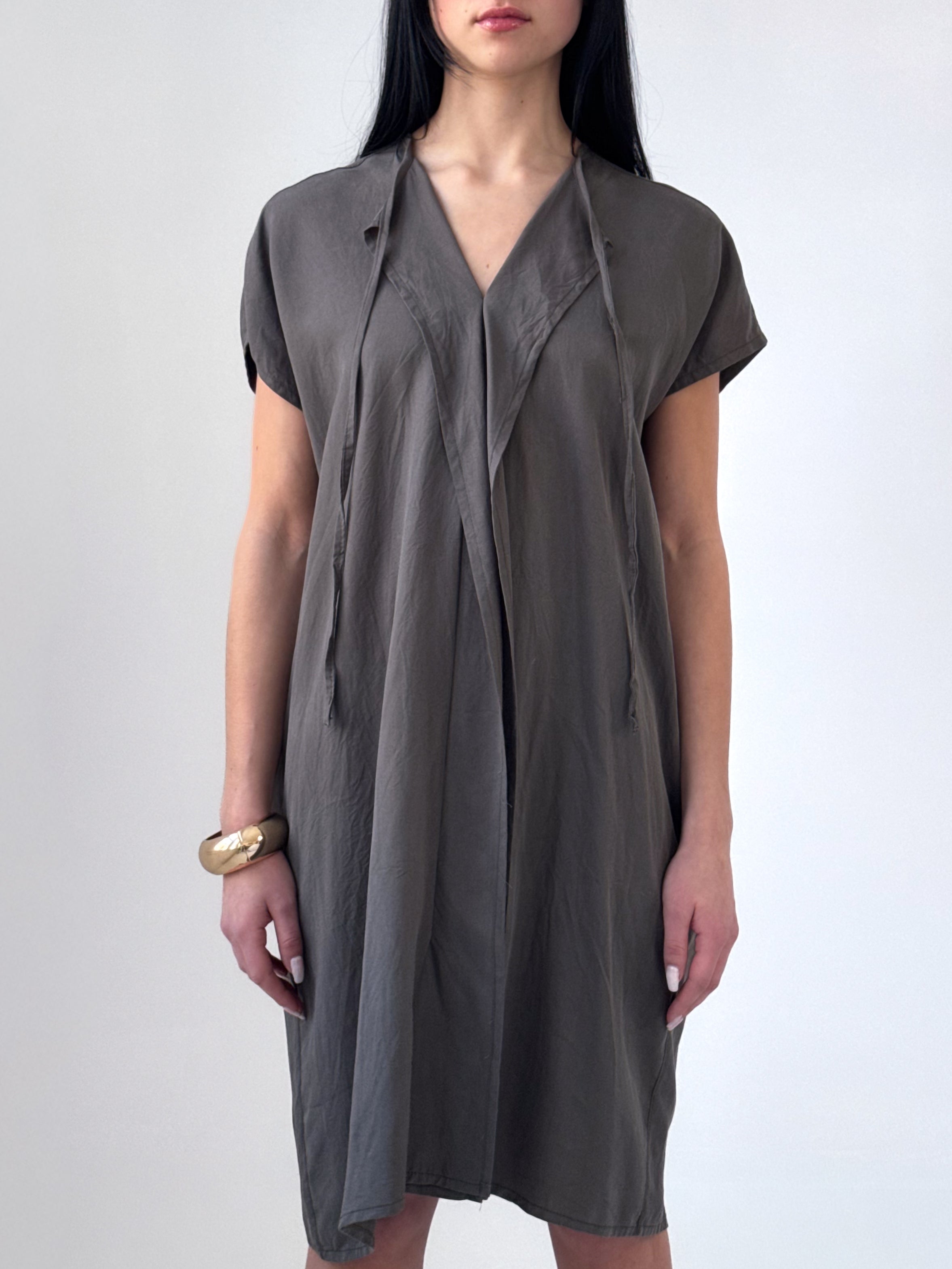 Relaxed washed tencel dress with a soft V neckline, front drape, and adjustable ties. Lightweight, breathable, and designed for fluid movement.