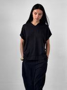 Lark washed tencel top with raw edge high V neckline and relaxed fluid silhouette, black minimalist blouse in modern understated style