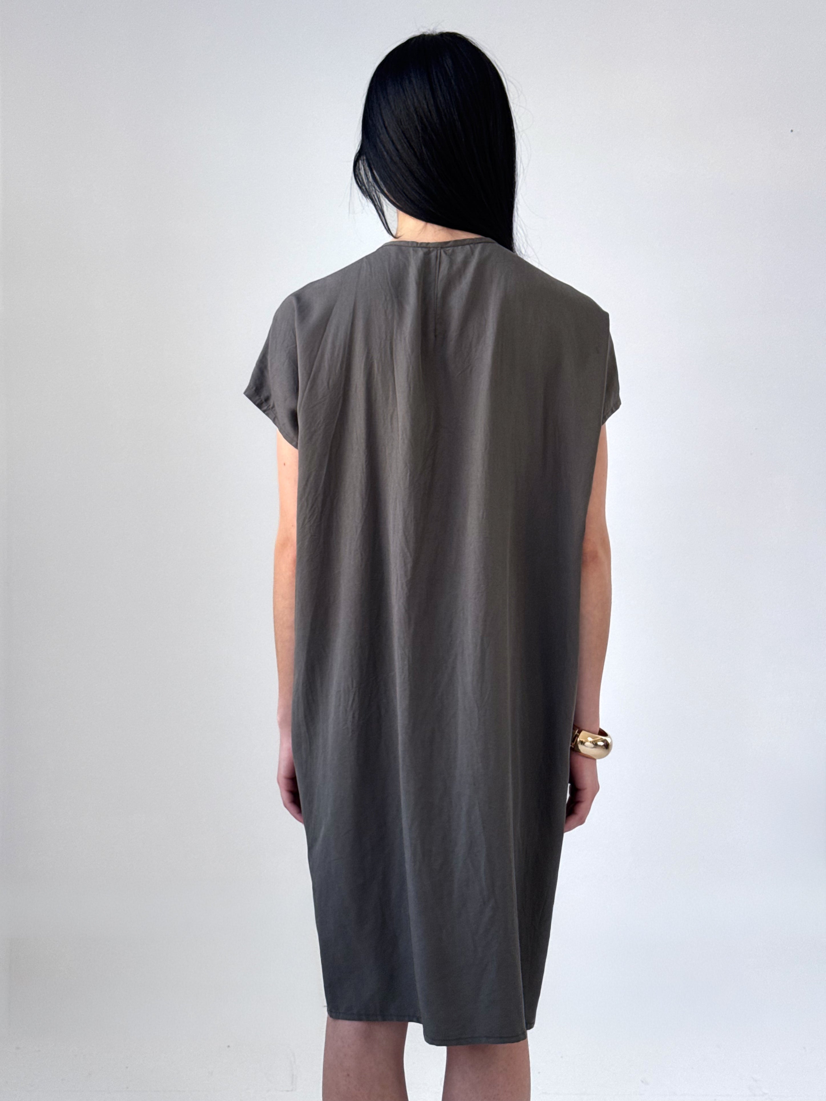 Relaxed washed tencel dress with a soft V neckline, front drape, and adjustable ties. Lightweight, breathable, and designed for fluid movement.