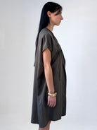 Relaxed washed tencel dress with a soft V neckline, front drape, and adjustable ties. Lightweight, breathable, and designed for fluid movement.
