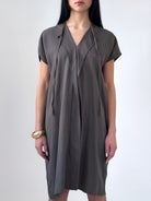 Relaxed washed tencel dress with a soft V neckline, front drape, and adjustable ties. Lightweight, breathable, and designed for fluid movement.