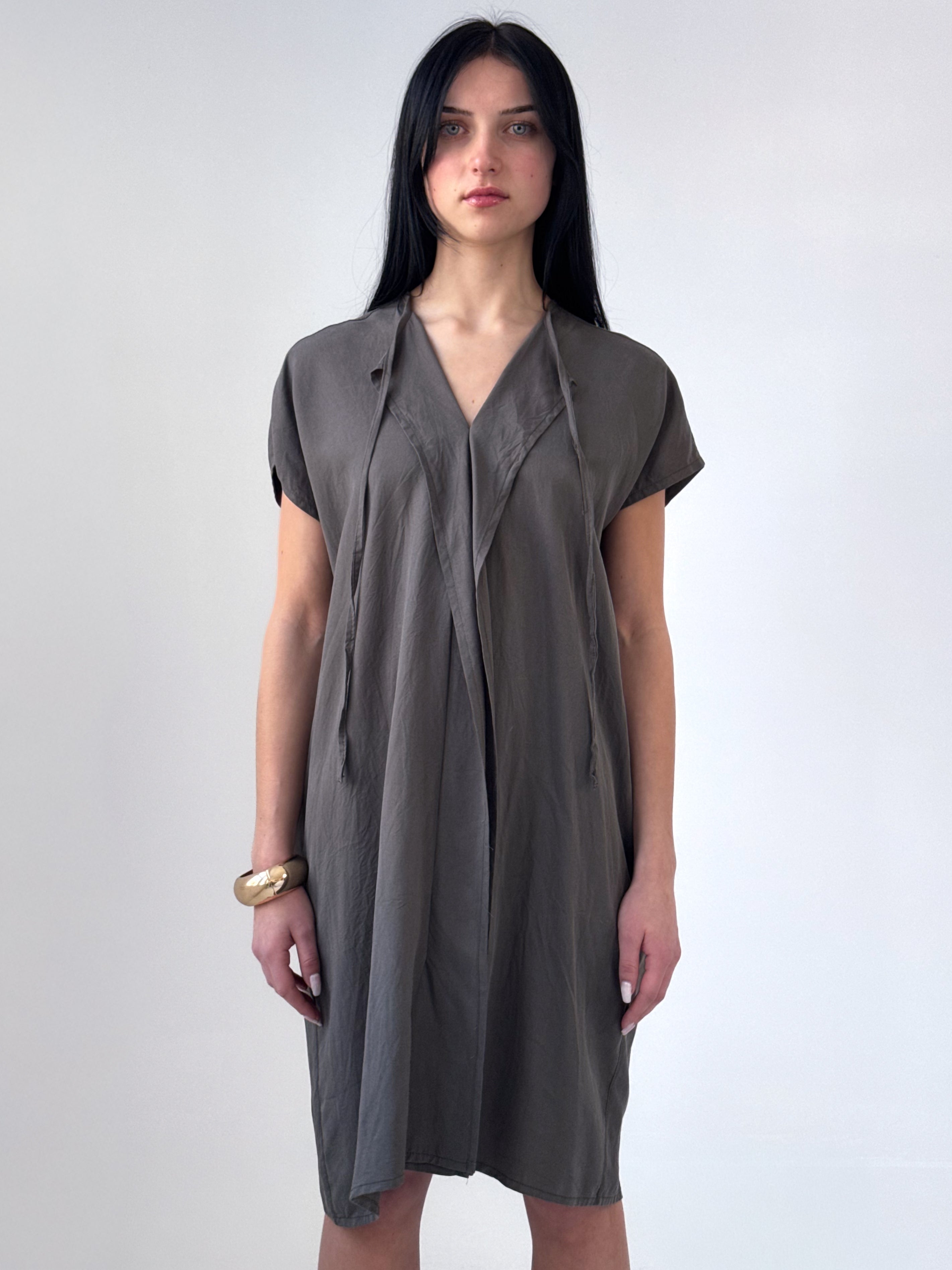 Relaxed washed tencel dress with a soft V neckline, front drape, and adjustable ties. Lightweight, breathable, and designed for fluid movement.