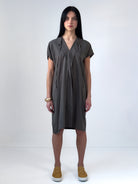 Relaxed washed tencel dress with a soft V neckline, front drape, and adjustable ties. Lightweight, breathable, and designed for fluid movement.