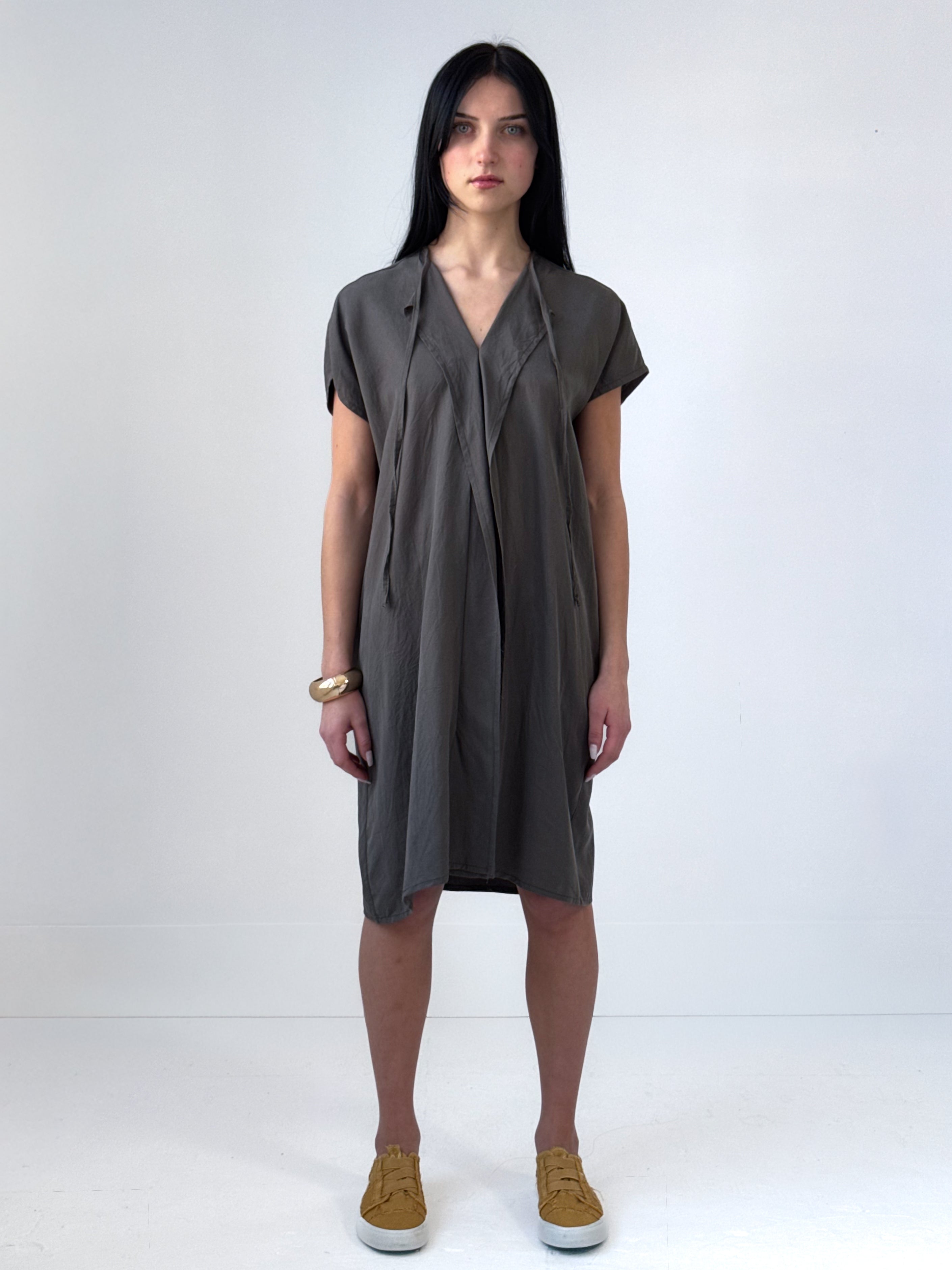 Relaxed washed tencel dress with a soft V neckline, front drape, and adjustable ties. Lightweight, breathable, and designed for fluid movement.