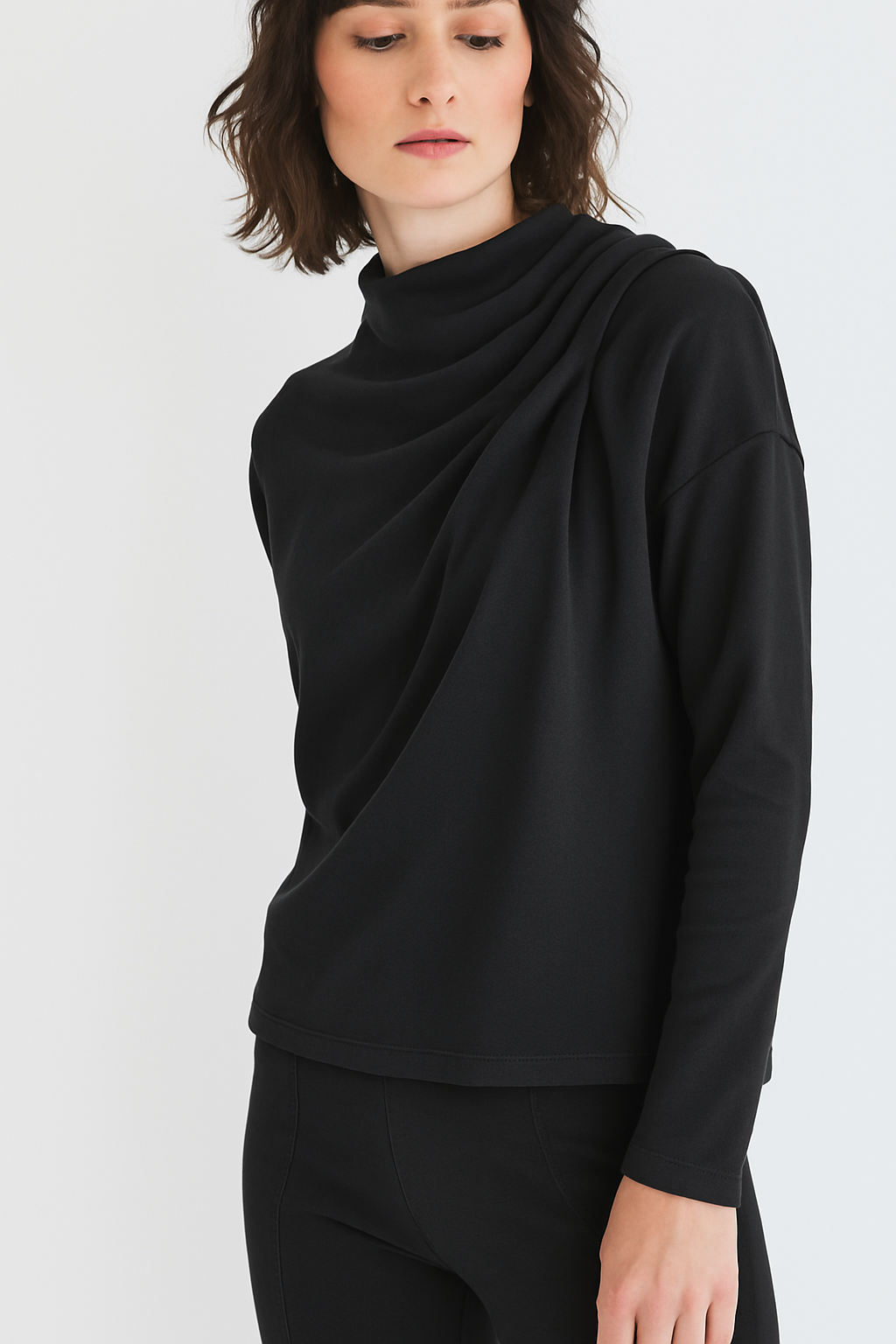 Woman wearing a black long-sleeve top on a white background